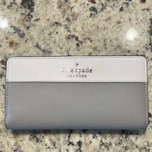 NWT Kate spade wallet. White/gray with black & silver accents.